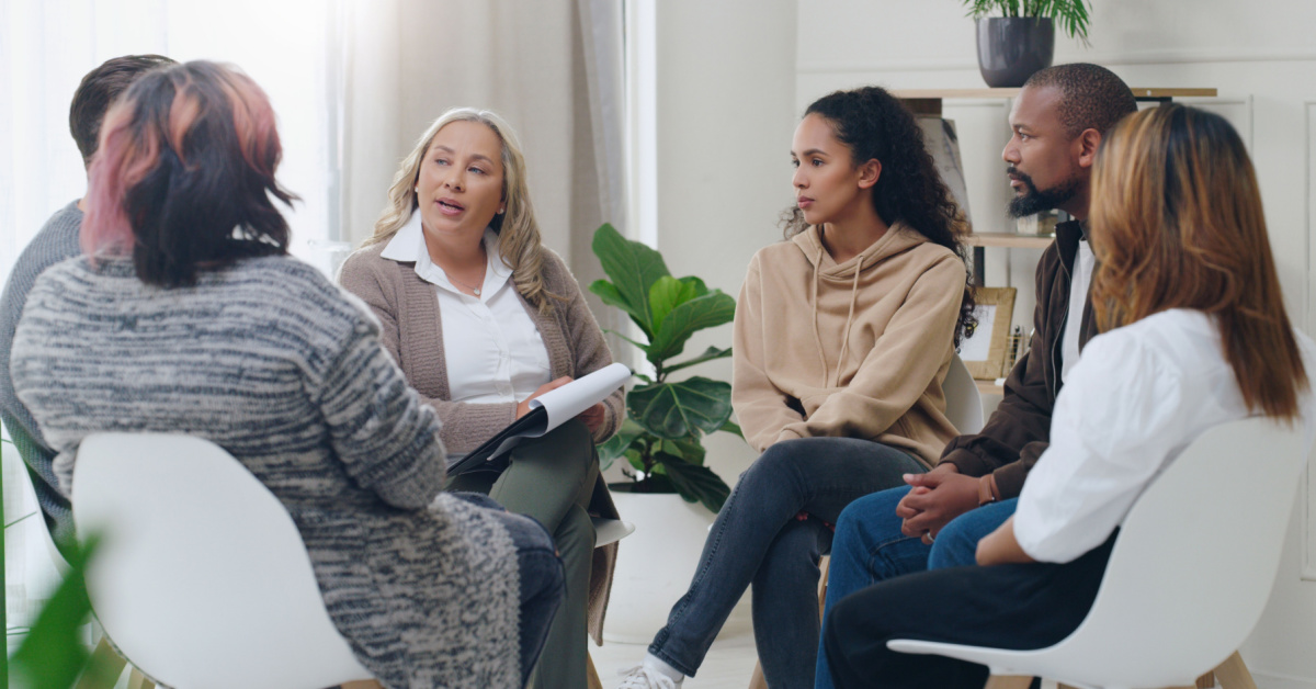 social worker working with a group of diverse people